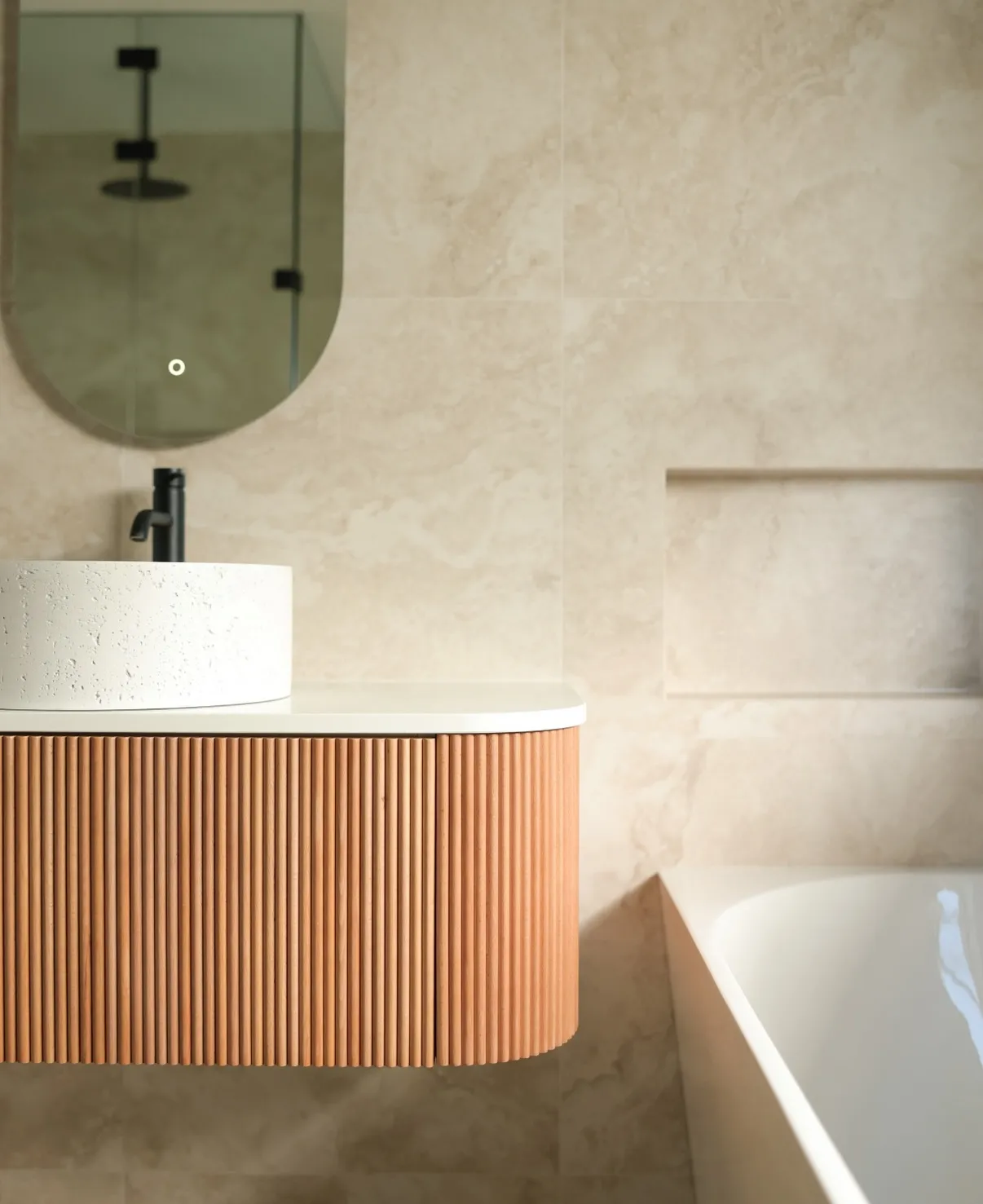 Lake Road bathroom with a warm timber vanity and natural light