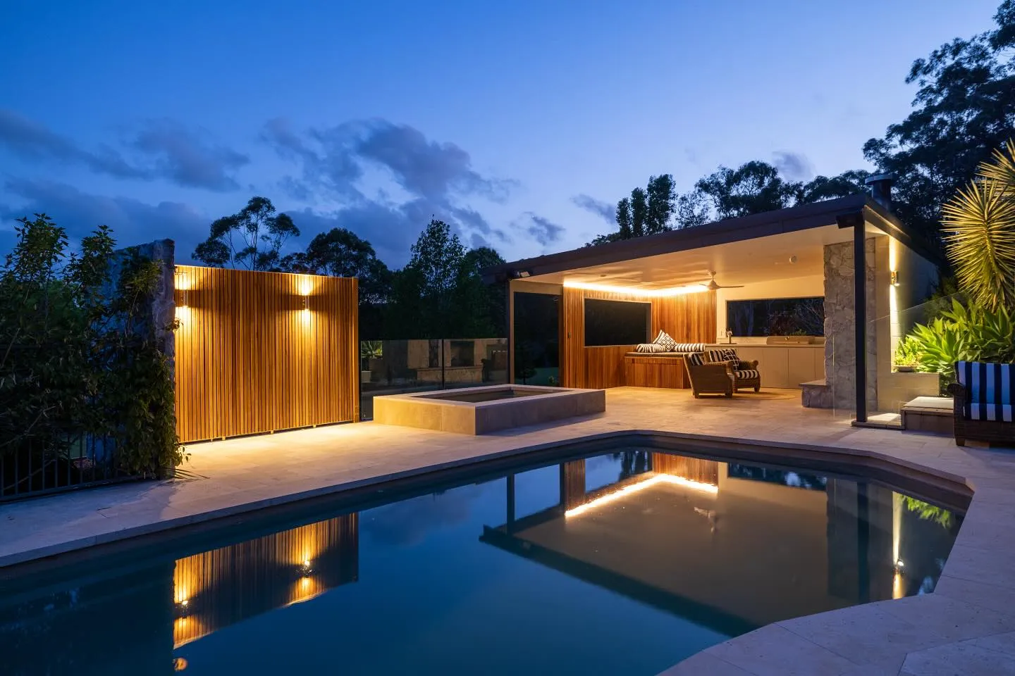 Tumbi Umbi pool house and outdoor entertaining area at dusk