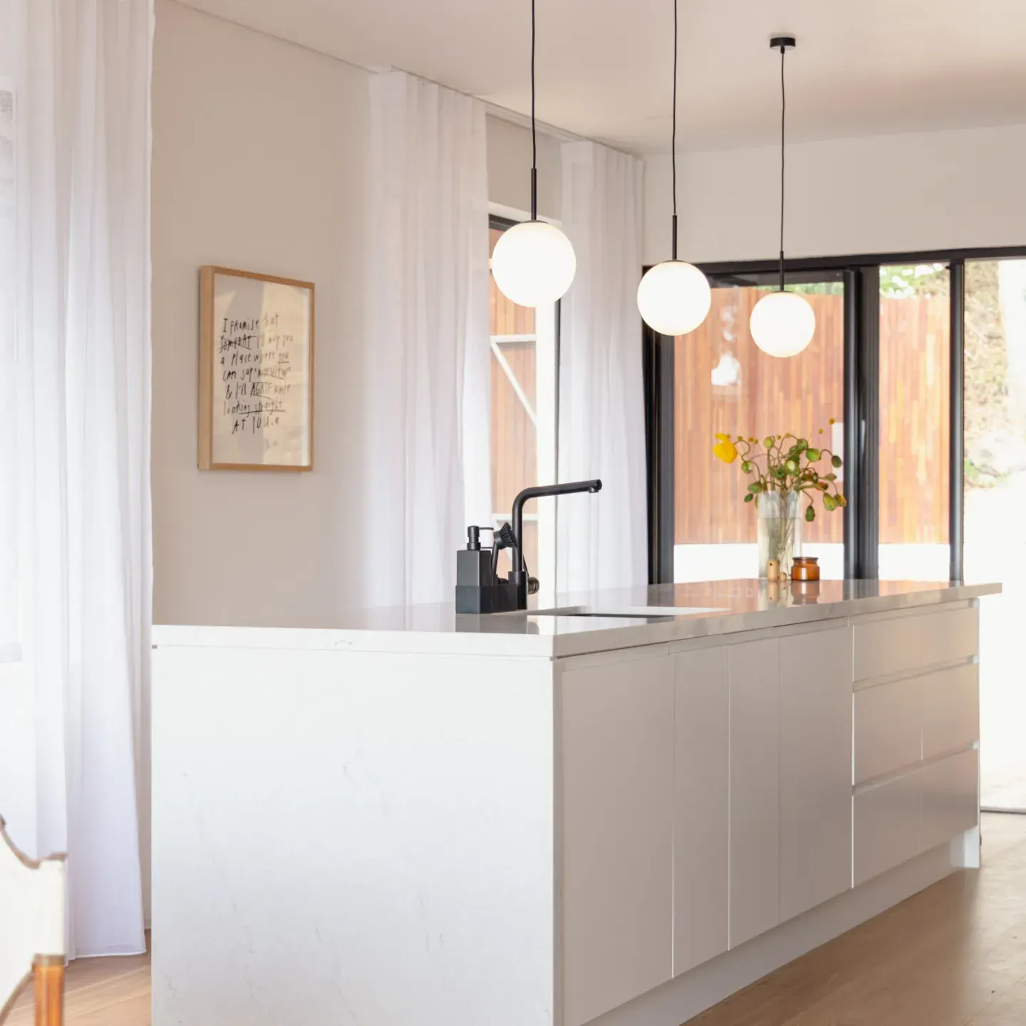 Coastal home kitchen transformation within a renovated 1950s brick home